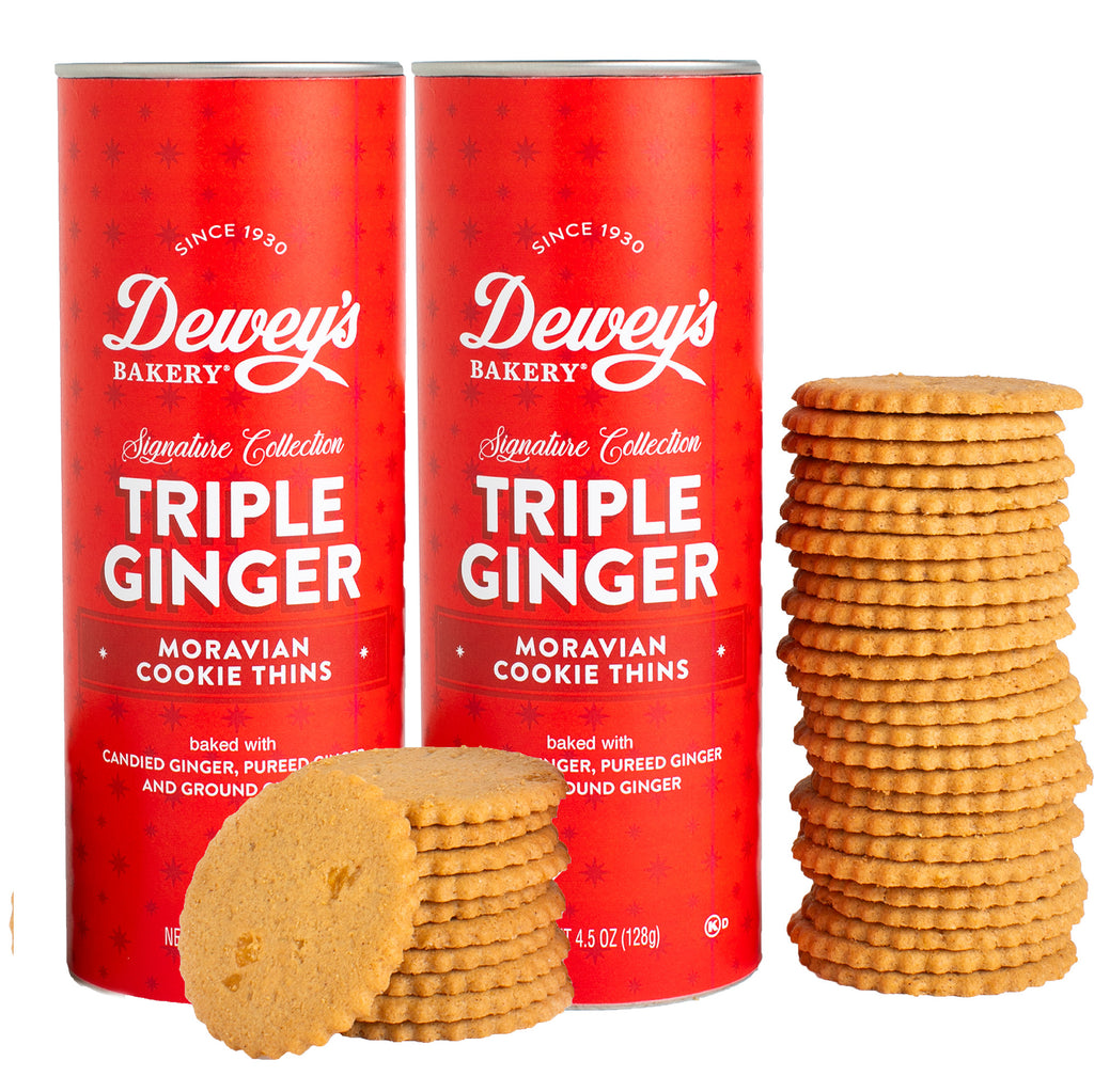 Two red cans of Dewey's Bakery Triple Ginger Moravian Cookie Thins with cookies on a white background.